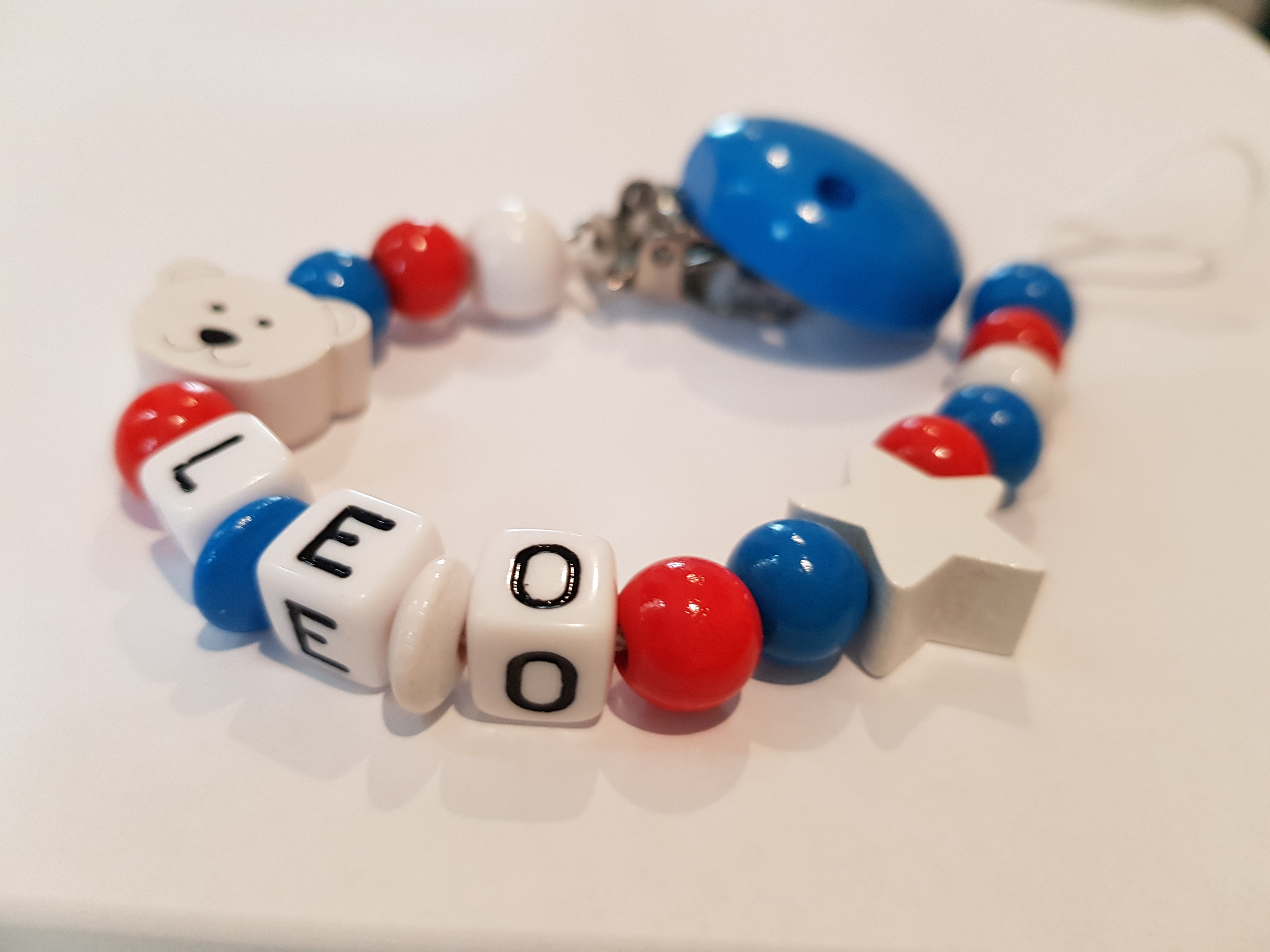 schnullerkette-mit-namen_blau_rot_weiss_teddy_stern Baby Schnullerkette mit Namen - Teddy Stern in blau rot weiß